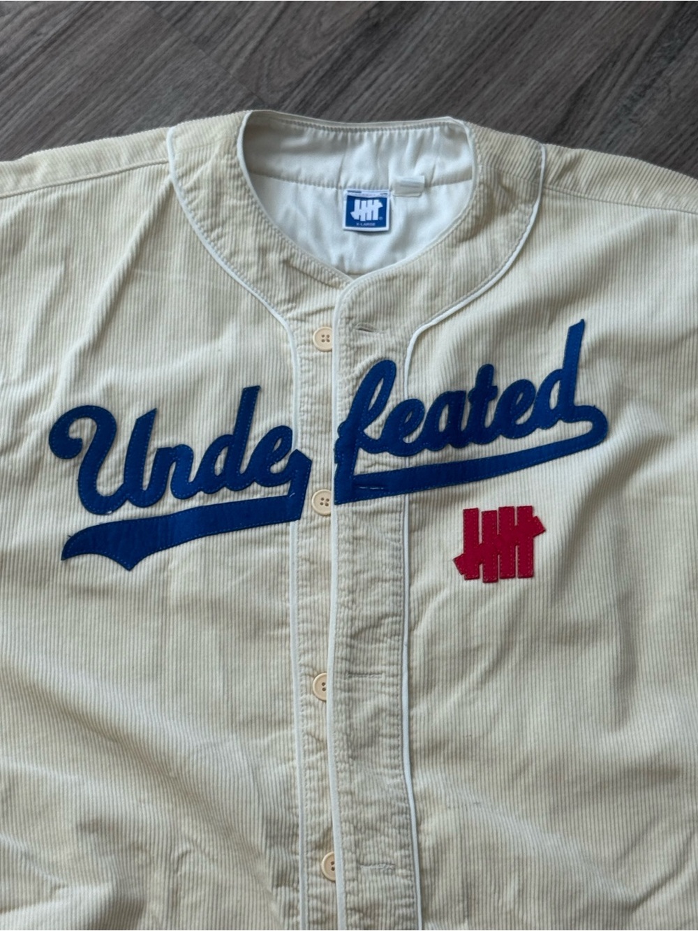 Undefeated Cream Corduroy Baseball Jersey with Blue Script and Red Logo